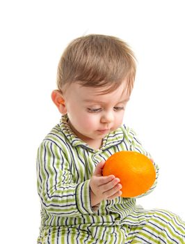 Lovely baby holding an orange