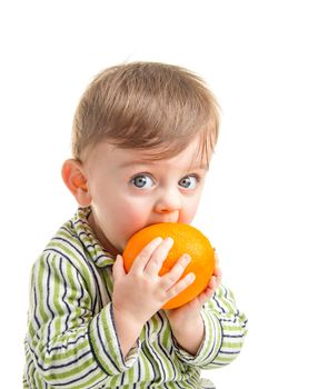 Lovely baby holding an orange