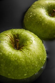 Two apples inside water with cool drops