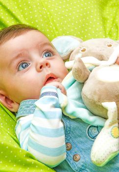 Little baby surprised by receiving his first toy