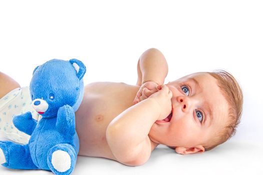 Cute blue eyed baby next to a toy