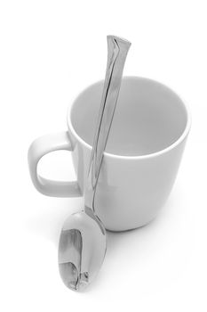 White mug and spoon on white background