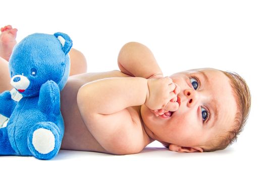 Cute blue eyed baby next to a toy