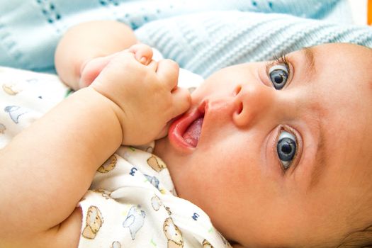 Cute blue eyed baby asking for a toy to play