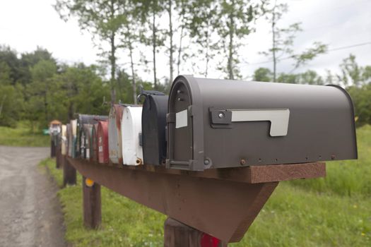 Rural mailboxes on a dirt road in the country.