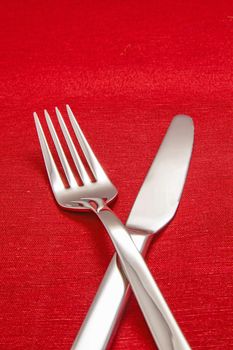 Silver Fork and knife on red table cloth