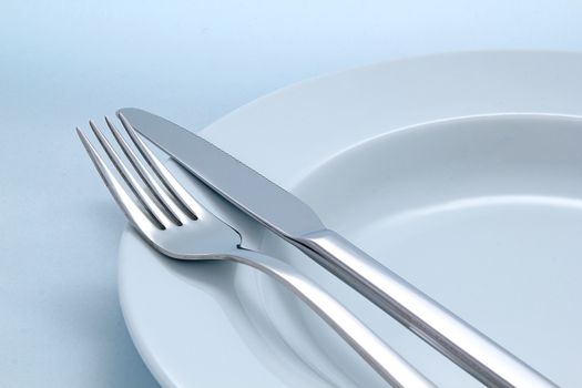 Silver Fork and knife on a dish