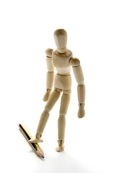 Wooden manikin and pencil on white background