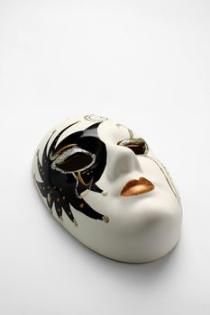 Funny mask on white surface