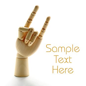 Wooden hand making horns sign with fingers over white