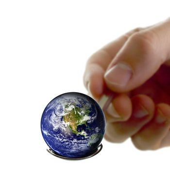 Hand holding a spoon with planet earth on top