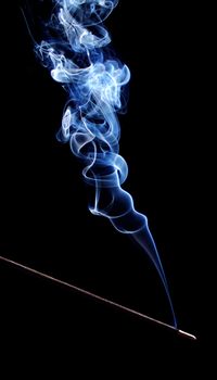 One burning incense straw with smoke