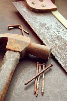 Old hammer, hand saw and nails
