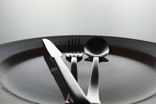 Silver Fork, knife and spoon on a dish