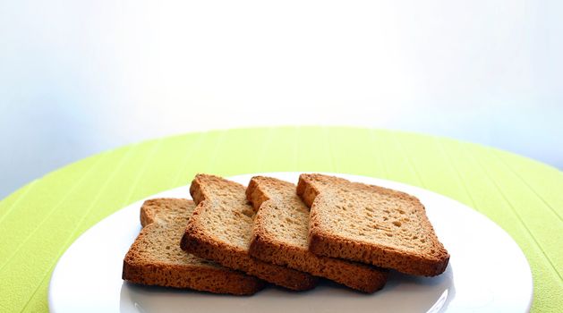 Background of four toasts over a white dish