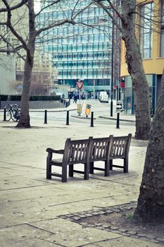 A wooden bench in an urban public space