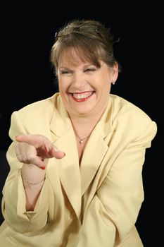 Mature businesswoman pointing and laughing.
