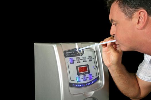 Man tests his alcohol level with a breath test machine.
