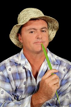 Contented farmer holding a blade of grass.