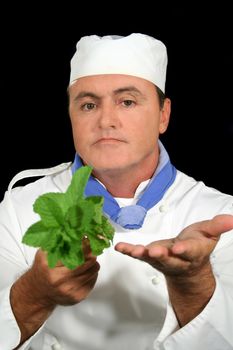 Chef showing fresh mint to a customer. 