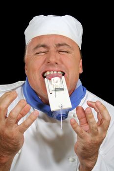 Chef in pain with mousetrap caught on his tongue.