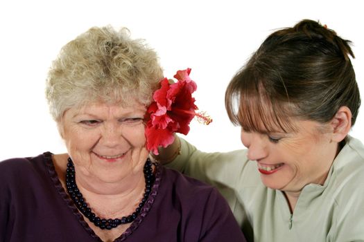 Daughter presenting mother with a hibiscus flower.