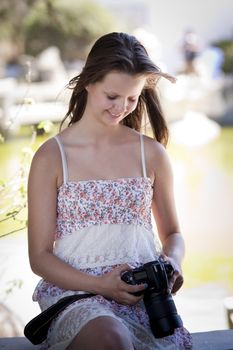 A teenager looking at photos taken with her digital slr camera, Candid shot, real people