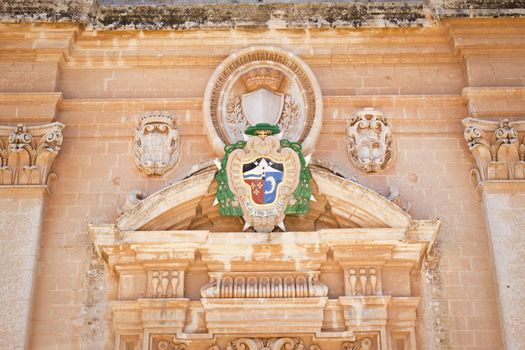 A coat of arms on the facade of the Mdina Cathedral in Malta. Plaza San Paul St. Paul's Cathedral