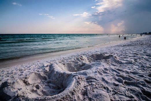 sand structures on beach near ocean waves