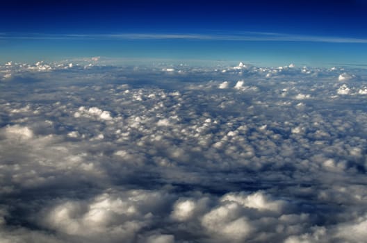 White clouds seen from above set against a blue sky