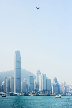 Helicopter in Hong Kong sky at sunset