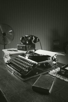 Old typewriter on a wooden desk in office