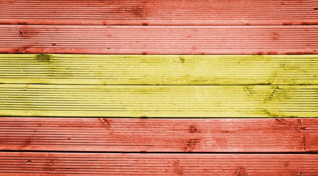 Natural wood planks texture background with the colors of the flag of Spain