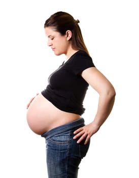 Beautiful expectant pregnant woman looking her belly isolated over a white background