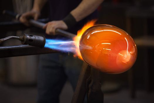 Blue and red flames on a hot glass vase