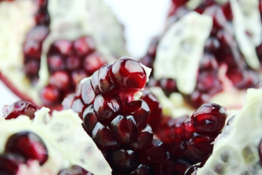 Part of pomegranate on white background.