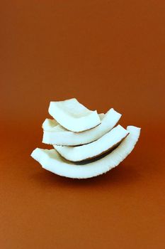 fresh Coconuts with parts on brown background