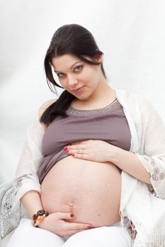 Pregnant woman looks at the pot-belly