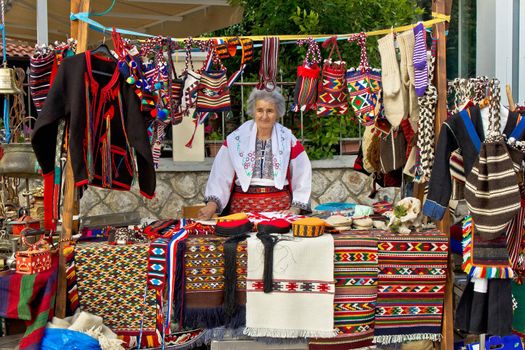 Lady in traditional clothes selling traditional croatian clothes on Biograd street fair, Dalmatia, Croatia