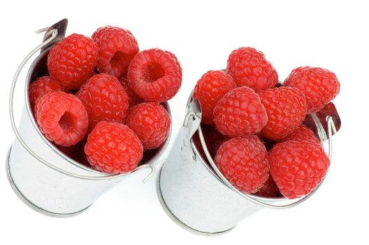 Arrangement of Tin Buckets with Perfect Ripe Raspberries isolated on white background
