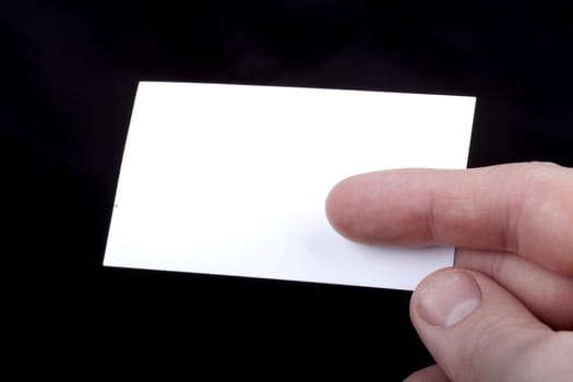 Man hand holding a blank business card.