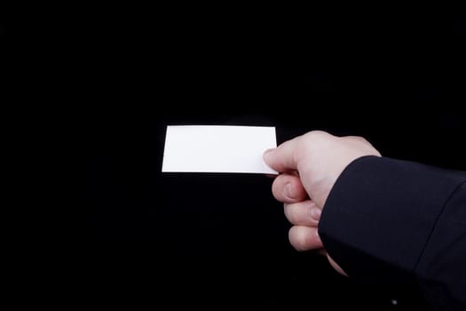 Man hand holding a blank business card.