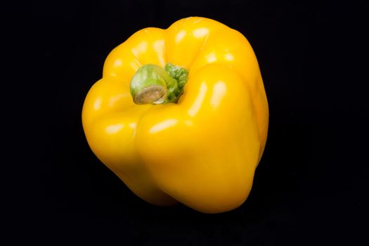 yellow pepper isolated on a black background