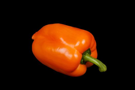 orange pepper isolated on a black background