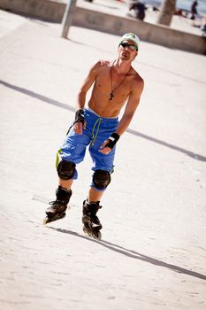 young man with inline skates in summer outdoor rollerblades skater