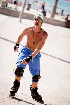 young man with inline skates in summer outdoor rollerblades skater