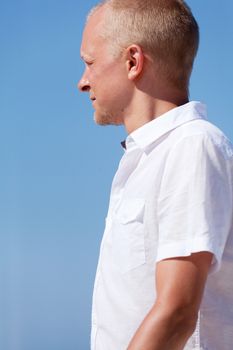 young man walking on the beach in summer holiday vacation