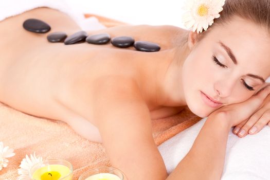 young attractive woman hot stone massage wellness isolated on white