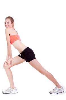 young attractive woman stretching legs after jogging isolated on white