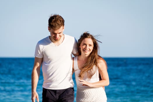 happy young couple on the beach carefree summertime holiday